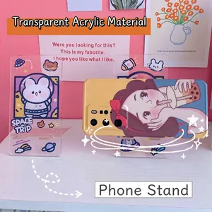 Transparent acrylic phone stands with cute bunny astronaut and cartoon girl designs.
