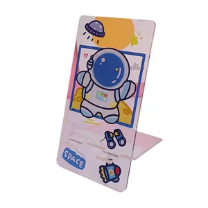 Portable transparent acrylic phone stand with a cute cartoon astronaut design