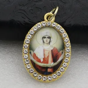 Detailed macro view of an oval religious icon pendant with rhinestone micro-setting