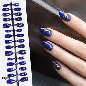 Detailed view of handmade dark blue cat-eye press-on nails with gold patterns.