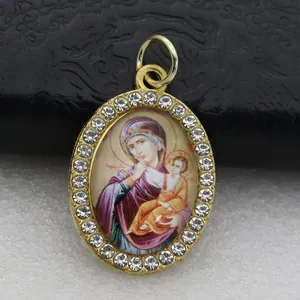 Vintage gold oval religious icon pendant with crystal border featuring Mary and Child