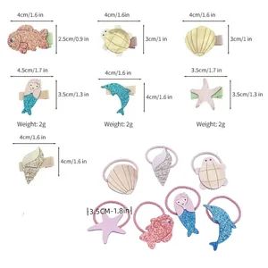 Detail view showing dimensions of ocean-themed glitter hair clips and ties.