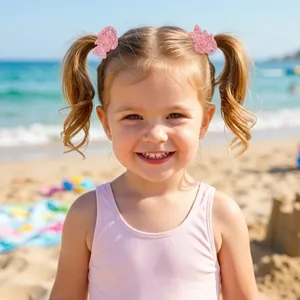 Little girl wearing sparkling pink fish glitter hair clips at a bright sunny beach
