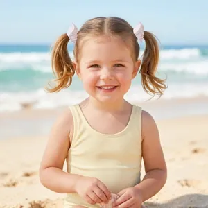 Little girl wearing adorable pink glittery shell hair clips at the sunny seaside beach