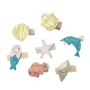 Set of 7 cute ocean animal PU leather hair clips for kids with glitter details.