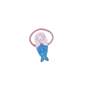 Close-up of a cute mermaid motif with blue glitter tail on a pink elastic hair tie