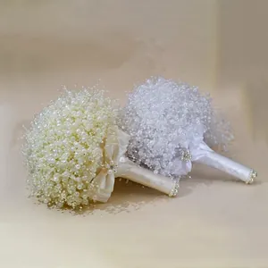 Detailed shot of handmade pearl wedding bouquets in white and cream color options