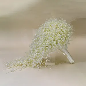 Elegant handmade cascading bridal bouquet featuring white pearls and satin wrapped handle