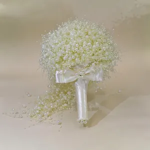 Close-up of pearl gypsophila bridal bouquet with elegant white satin ribbon