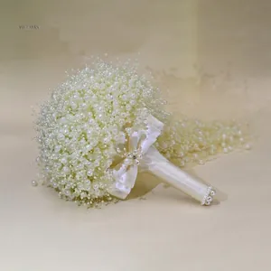 Detailed view of handmade pearl baby's breath bridal wedding bouquet with silk ribbon