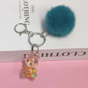 Portachiavi con pompon verde acqua e ciondolo a forma di orsetto