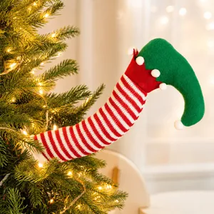 Close-up of a festive red and white striped elf leg decoration on a Christmas tree