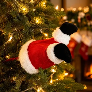 Close-up of plush Santa Claus legs stuck in a decorated Christmas tree