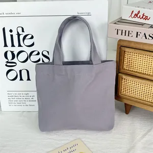 Detailed view of a minimalist purple canvas tote bag in a lifestyle setting
