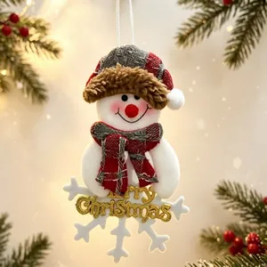 Plush snowman Christmas tree ornament with plaid hat and golden Merry Christmas sign.