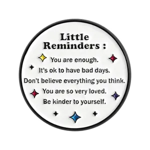 Cute white circular enamel pin badge with motivational Little Reminders quotes and stars