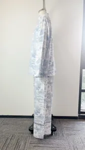 Side view profile of an elegant blue and white toile print shirt and wide-leg pants set