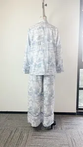 Back view of women's elegant blue landscape print shirt and wide-leg pants set