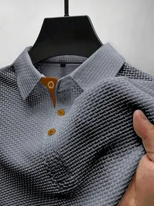 Close-up detail shot of the grey ice silk mesh texture on a premium men's polo shirt.