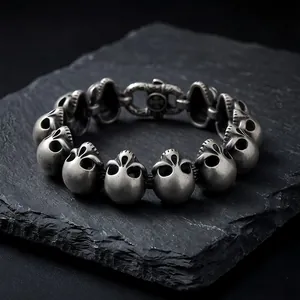 Detailed view of punk style titanium steel skull bracelet for men on slate stone