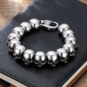 Detailed view of a men's titanium steel skull bracelet with a gothic silver finish.