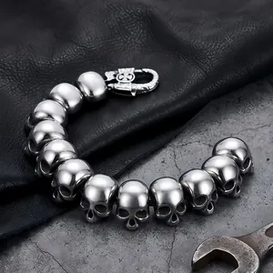 Close-up detail of gothic titanium steel skull bracelet for men on textured leather
