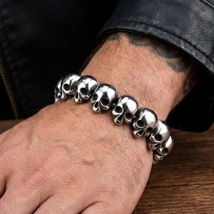 Macro view of men's gothic skull bracelet made from polished titanium steel.