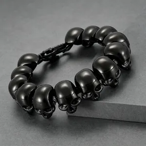 Close-up of black titanium steel skull bracelet showing detailed texture.