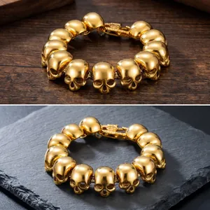 Detailed macro view of a men's gold-plated titanium steel skull bracelet on slate surface