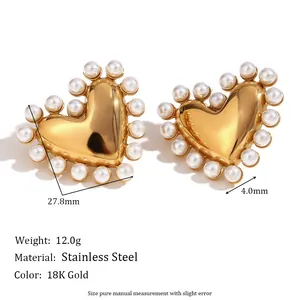Detail view of 18K gold plated stainless steel heart earrings with pearl trim