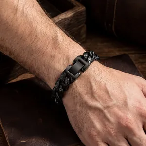 Close-up of a black titanium steel Cuban link bracelet with vintage engravings