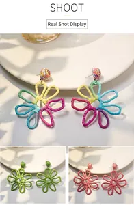 Close-up detail of hand-woven colorful raffia hollow flower earrings in summer style