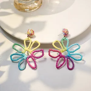 Vibrant hand-woven colorful raffia hollow flower earrings for a summer vacation look