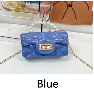 Mini blue rhombic jelly bag featuring a pearl handle and a delicate gold chain strap