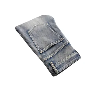 Men's washed blue flare jeans folded neatly, featuring a classic high street denim style
