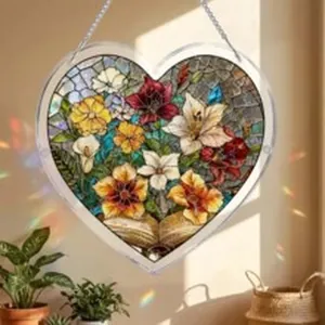 Detailed view of heart-shaped acrylic suncatcher with vibrant floral and book patterns