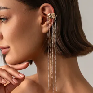 Detailed view of an elegant gold ear cuff with long multi-layer tassel chains