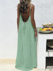 Close-up of the backless design and thin straps of a sage green loungewear slip dress
