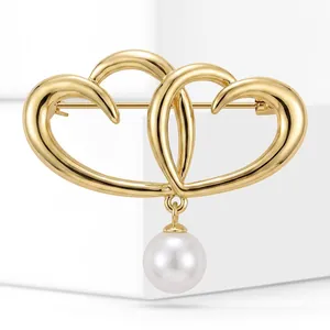 Elegant gold-finished double heart brooch with a hanging lustrous white pearl detail