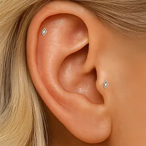 Detailed view of S925 sterling silver diamond-shaped zircon ear bone stud on a human ear.
