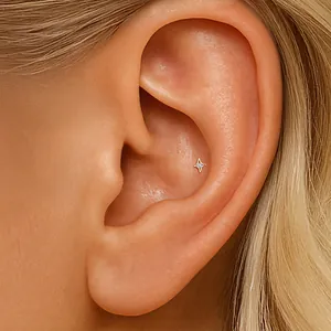 Delicate S925 sterling silver star flat back piercing with zircon shown on the ear conch.