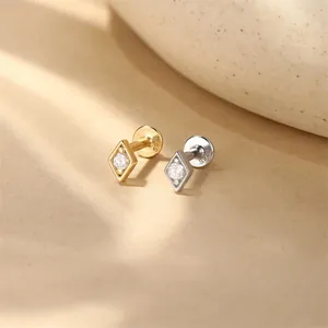 Detailed view of S925 silver diamond-shaped zircon labret piercing in gold and silver