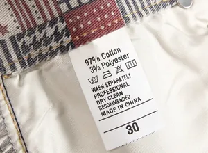 Detail of garment care label showing 97% cotton material and washing instructions