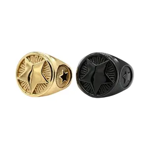 Detailed view of vintage gold and black titanium steel rings with star design.
