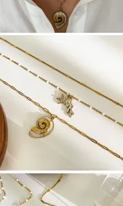 Detailed close-up of 18K gold plated titanium steel starfish and sea snail necklace set