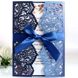 Elegant navy and light blue laser-cut wedding invitation card with satin ribbon