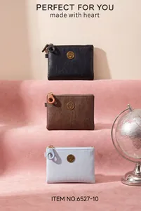Detailed view of three stylish PU leather zip coin purses in black, brown and light blue