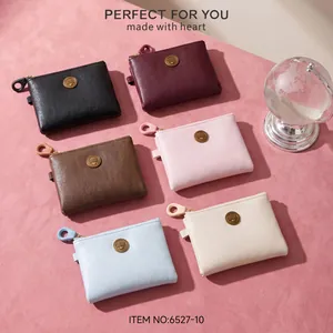 Assorted colors of women's short PU leather wallets featuring a zipper and metal emblem.