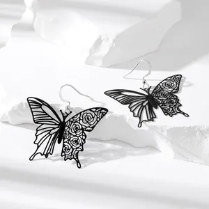 Elegant black hollow butterfly drop earrings with rose patterns on textured white stone