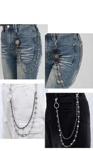 Detailed views of punk style waist chains with dice and skull charms on various jeans.